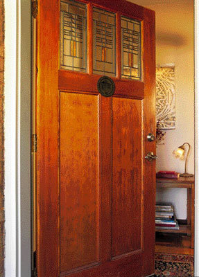 At the front steps of a renovated Chicago bungalow, a Craftsman-style Simpson door invites guests into the home. Preserving art-glass windows is a mainstay of bungalow authenticity.